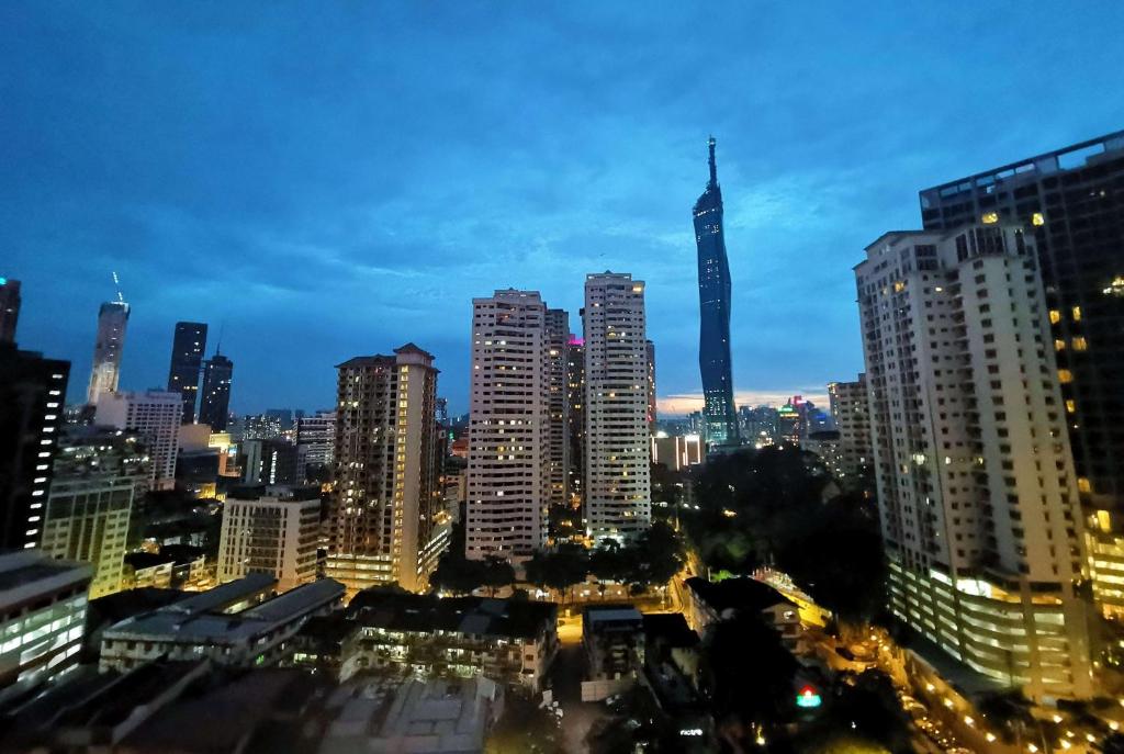 a city skyline at night with tall buildings at Ramada Suites by Wyndham Kuala Lumpur City Centre in Kuala Lumpur