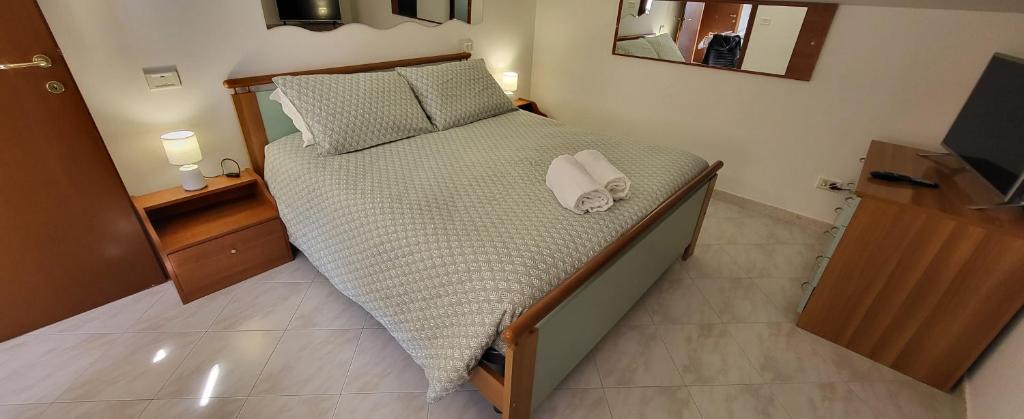 a bedroom with a large bed with two towels on it at Residenza Infante in Avezzano
