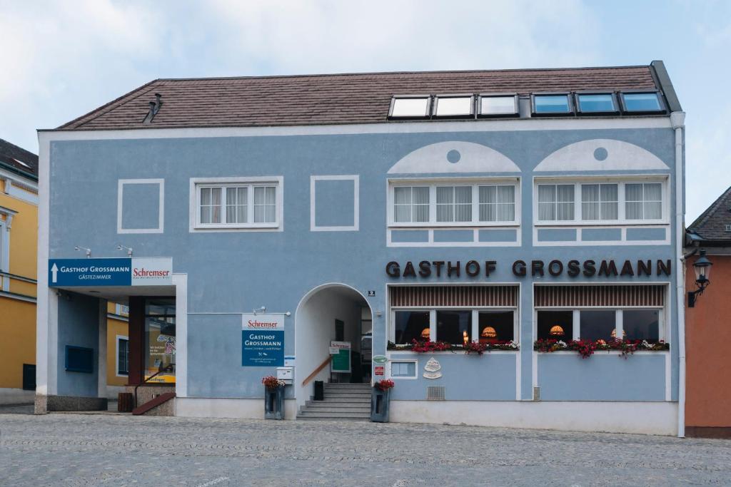 a blue building with a store on a street at Gasthof Großmann in Heidenreichstein