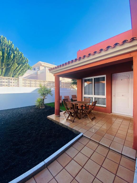 a patio with a table and chairs in front of a house at Sun&Beach 5 in Caleta De Fuste