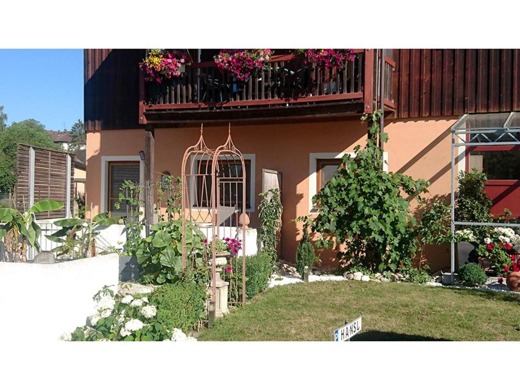 a house with a balcony with flowers on it at Haus Rottauenblick in Bad Birnbach