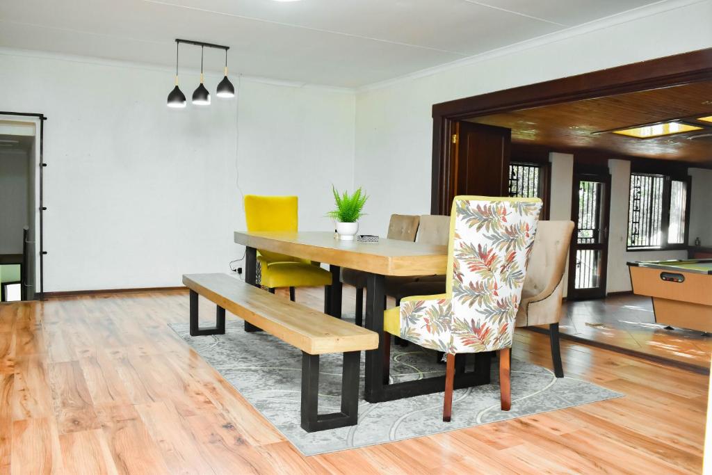 a dining room with a table and a chair at MTH in Nelspruit