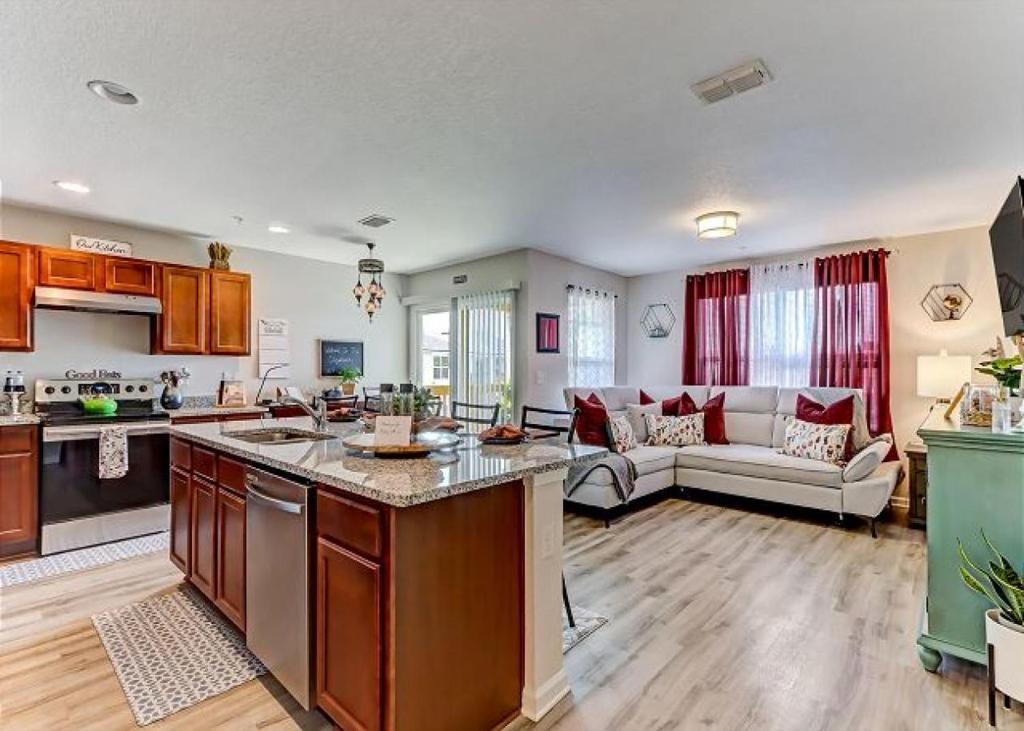 a large kitchen and living room with a couch at The Elizabeth in Jacksonville