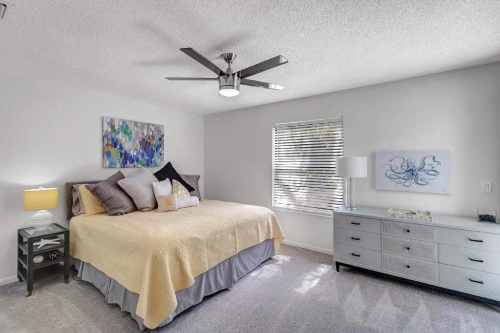 a bedroom with a bed and a ceiling fan at PV Clubhouse in Ponte Vedra Beach