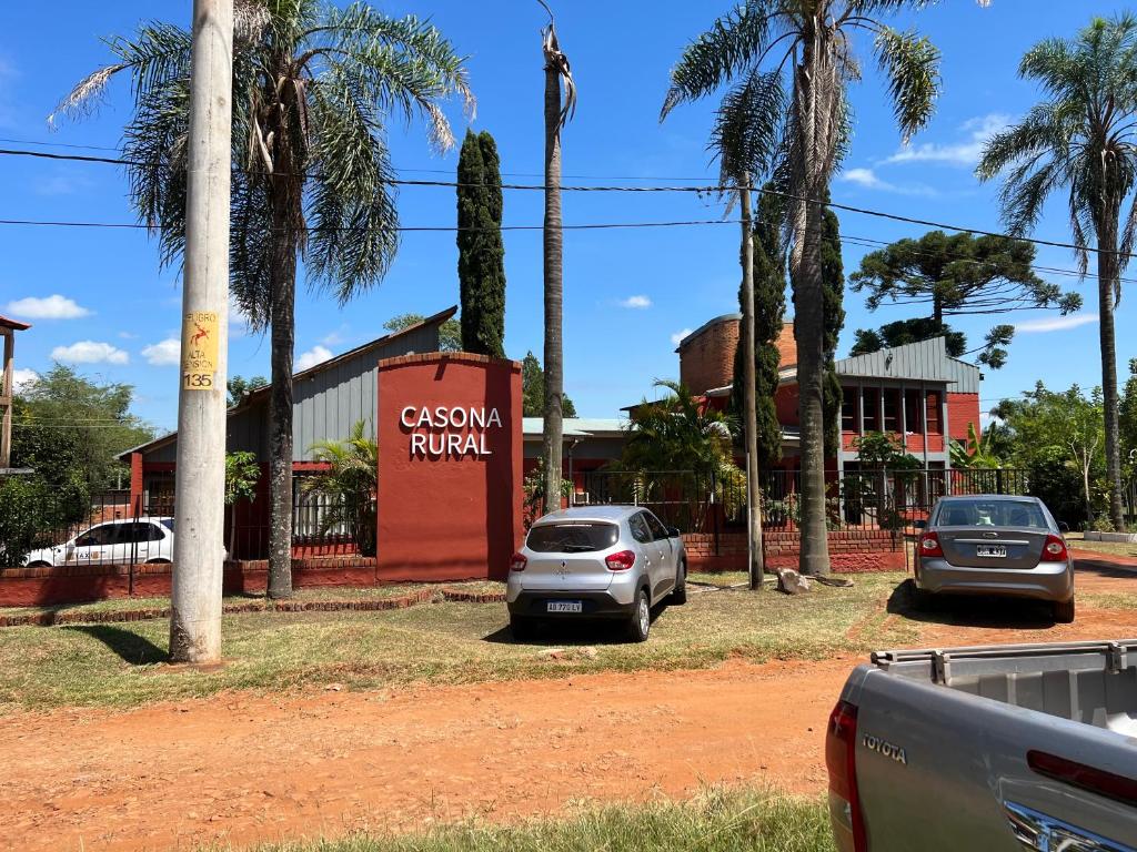 two cars parked in a parking lot in front of a building at Casona Rural alquiler temporal in Puerto Rico
