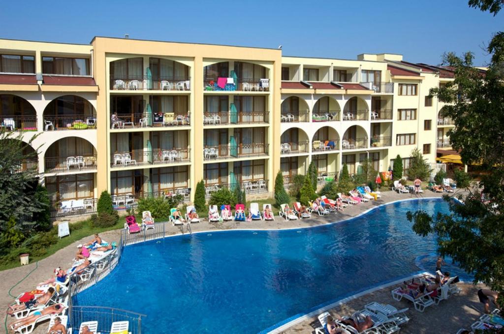 a hotel with a large swimming pool in front of it at Yavor Palace Hotel - All Inclusive in Sunny Beach