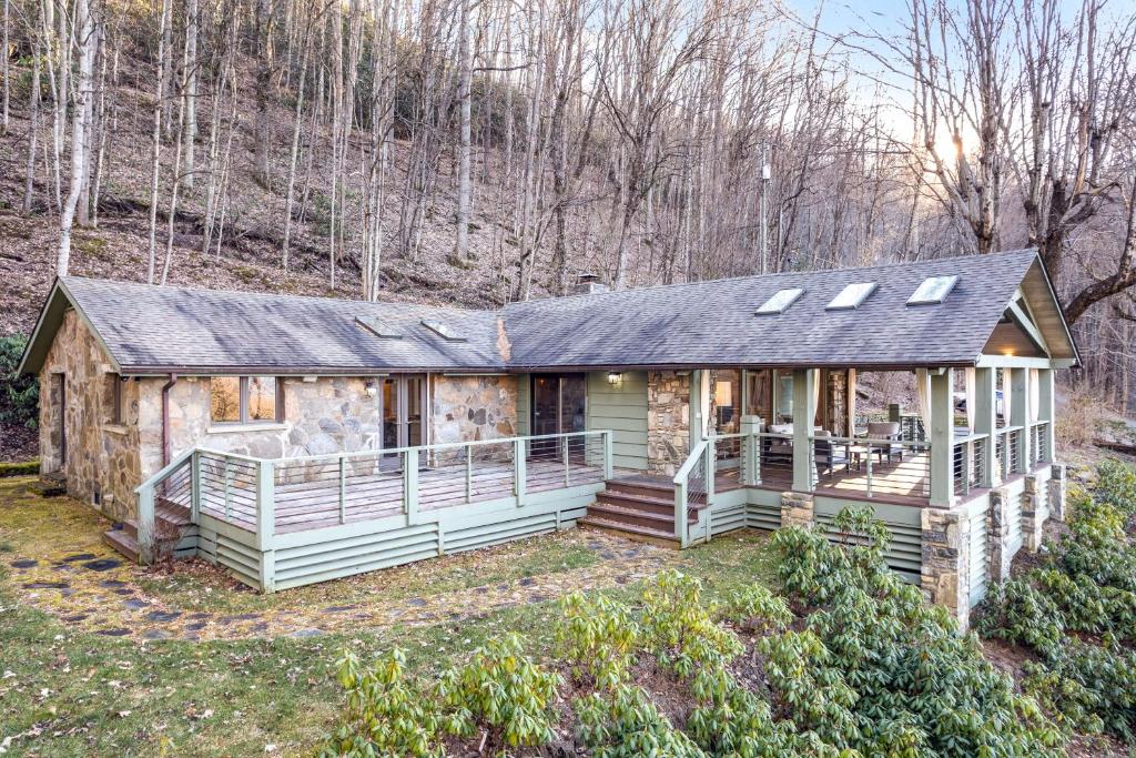 a home in the woods with a large house at Shadowood Serenity in Waynesville