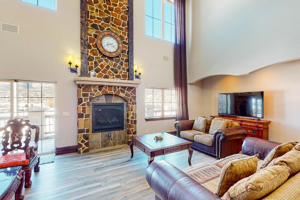 a living room with a couch and a fireplace at Black Bear Lodge in Eagle