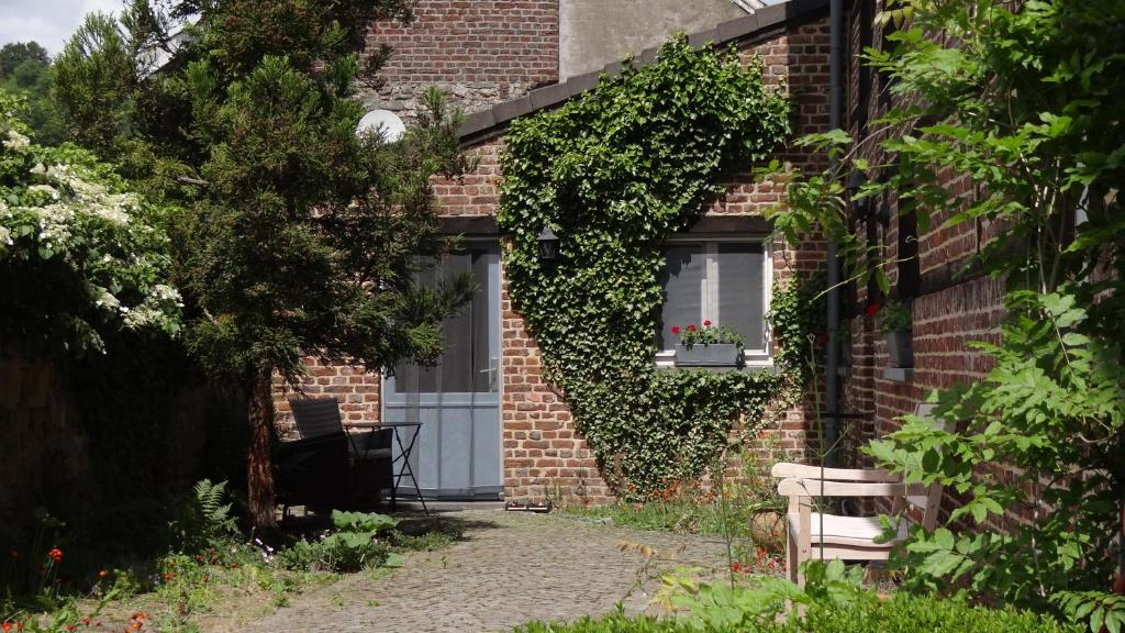 a brick building with a door and a window at Hoeve Espewey - Studio 
