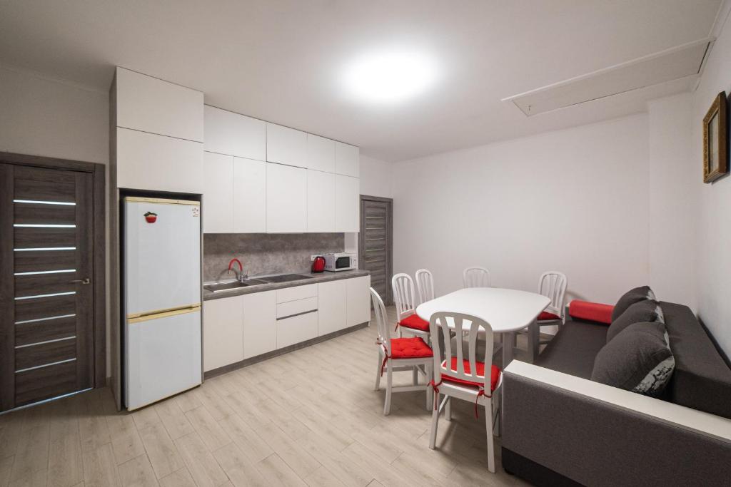 a kitchen and dining room with a table and a refrigerator at Zarinok House in Skole