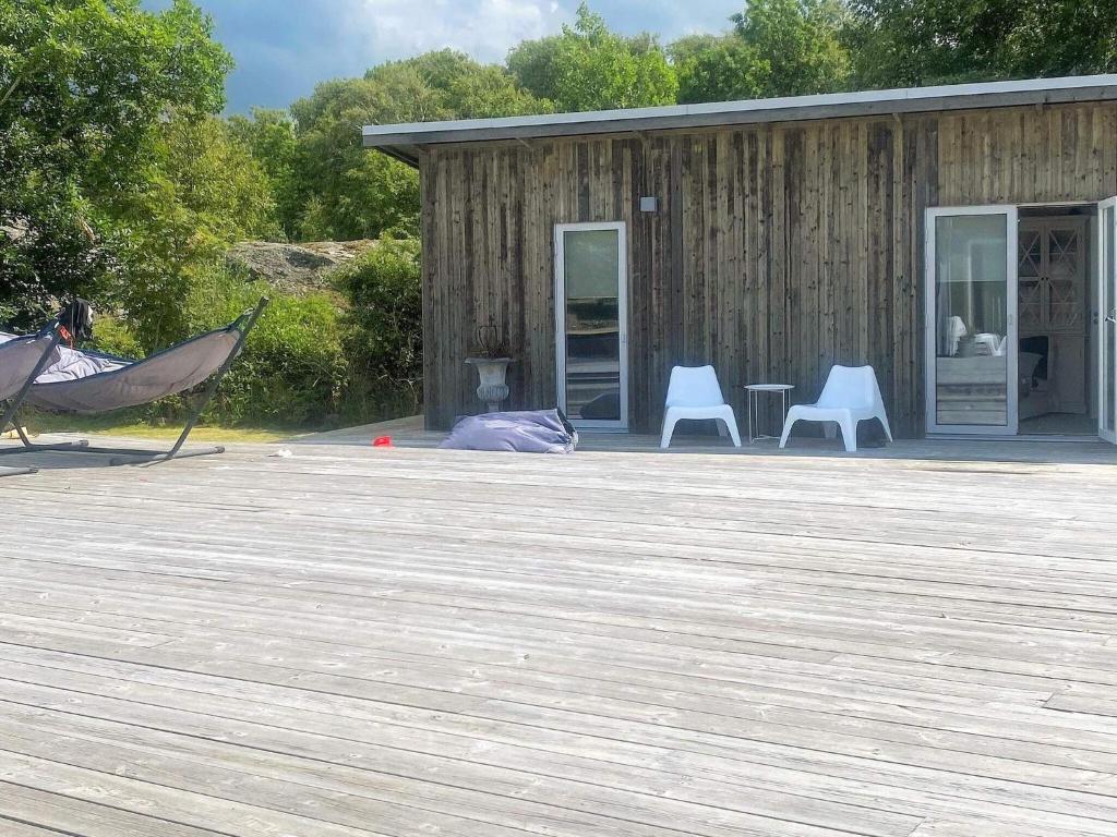 a hammock on a deck in front of a building at 9 person holiday home in ELLÖS-By Traum in Ellös