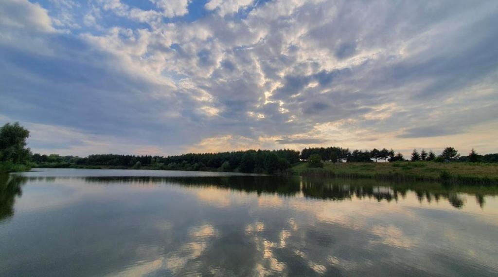 a large body of water with a cloudy sky at Family Resort in Mostiska