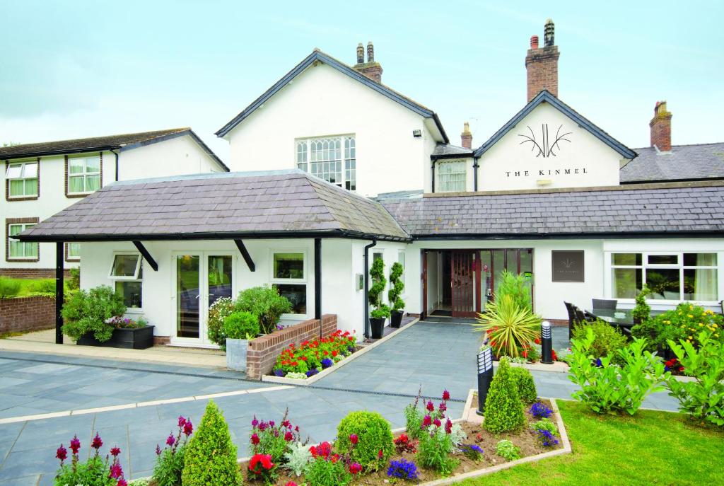 a white house with a red roof and a white house at The Kinmel & Kinspa in Abergele