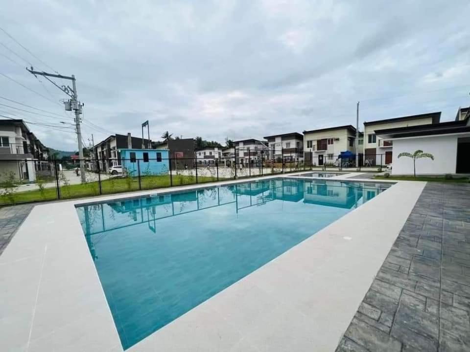 a large swimming pool with blue water at Modena Town Square-Walkup Condominium in Minglanilla