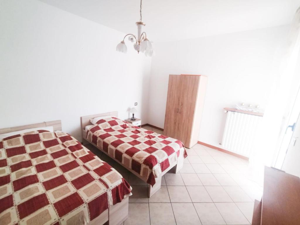a hotel room with two beds and a window at 1000MigliaHouse in Brescia