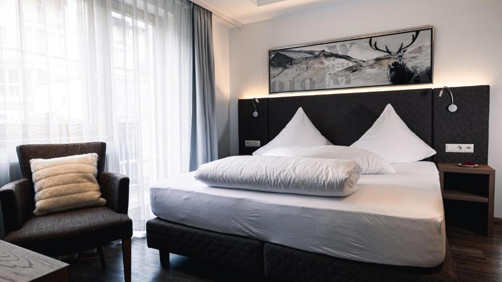 Postel nebo postele na pokoji v ubytování Hotel Alpina