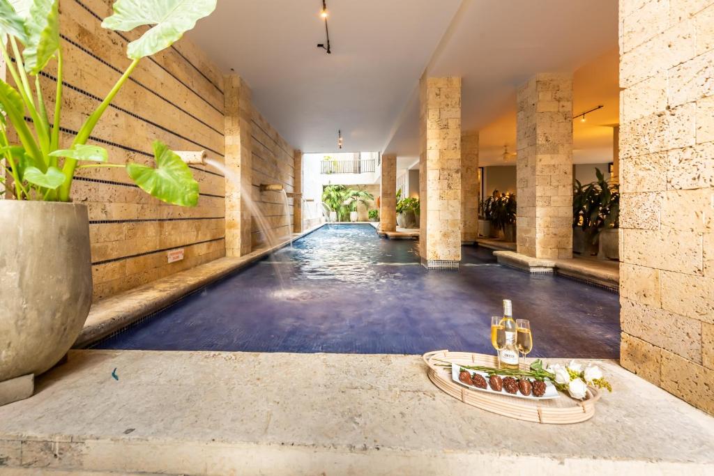 an empty pool in a house with a swimming pool at Madisson Boutique Hotel Cartagena in Cartagena de Indias