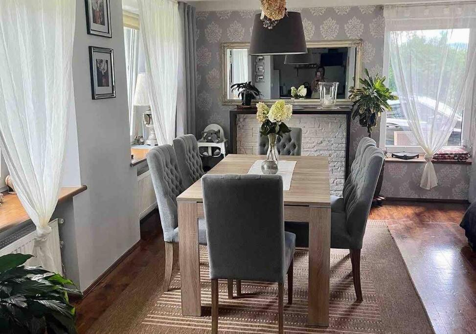 a dining room with a wooden table and chairs at Domek w Karkonoszach in Karpacz