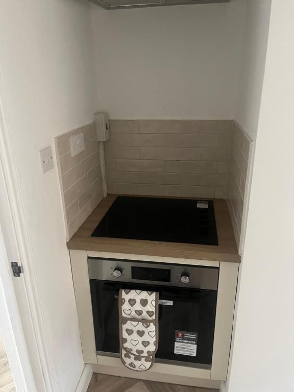 a small kitchen with a stove top oven at Modern welsh cottage in Porth