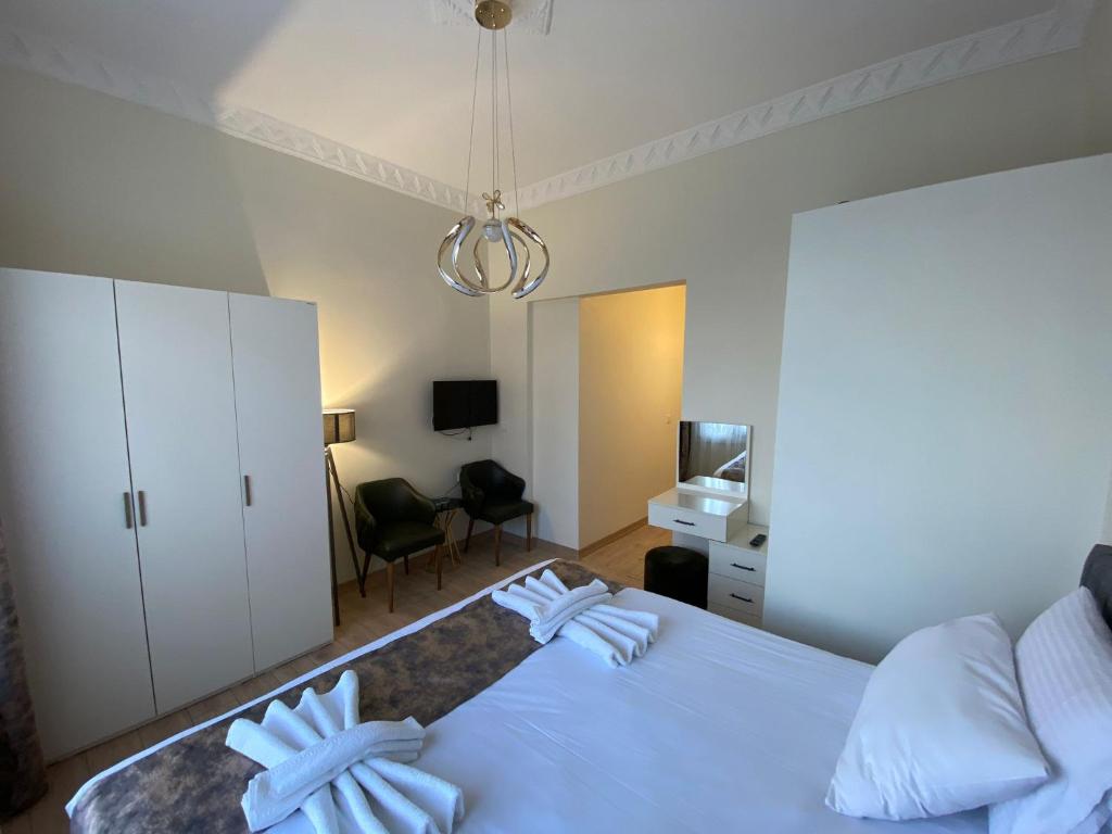 a bedroom with a large white bed and a desk at Bonita Apart in Istanbul
