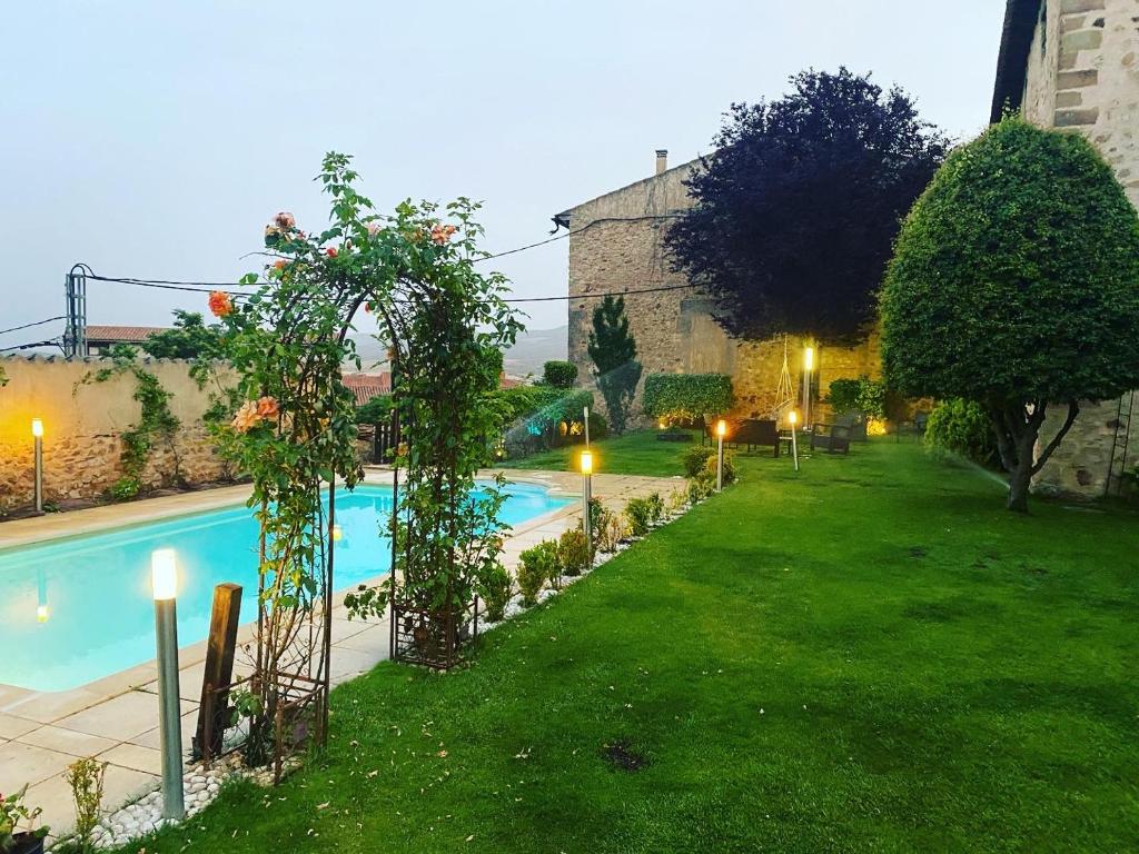 a garden with a swimming pool at night at Antiguo Palacio De Atienza in Atienza