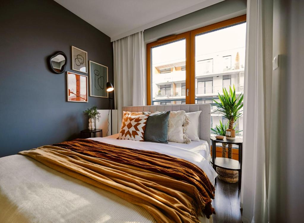 En eller flere senge i et værelse på Przytulny Apartament Greenwall