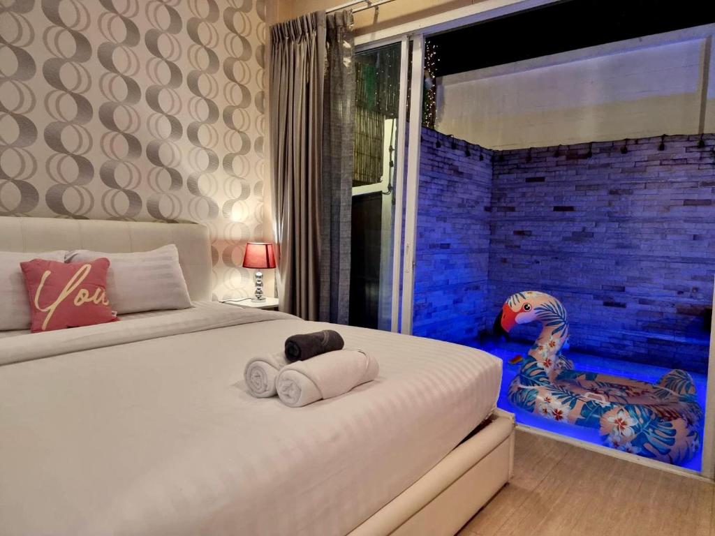a bedroom with a bed with towels on it at ChinJu PoolVilla in Jomtien Beach