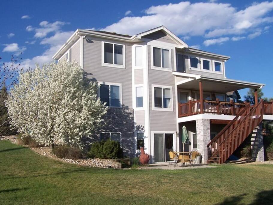 a large white house with a porch and a deck at Beautiful home 10 min E of Boulder in Lafayette