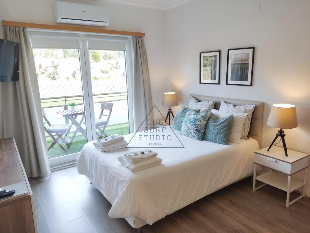 a bedroom with a bed with a sign on it at The Surf Studio - Ericeira in Ericeira