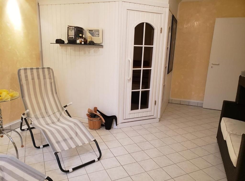 a living room with a chair and a window at Wanderoase Ibental in Asbach