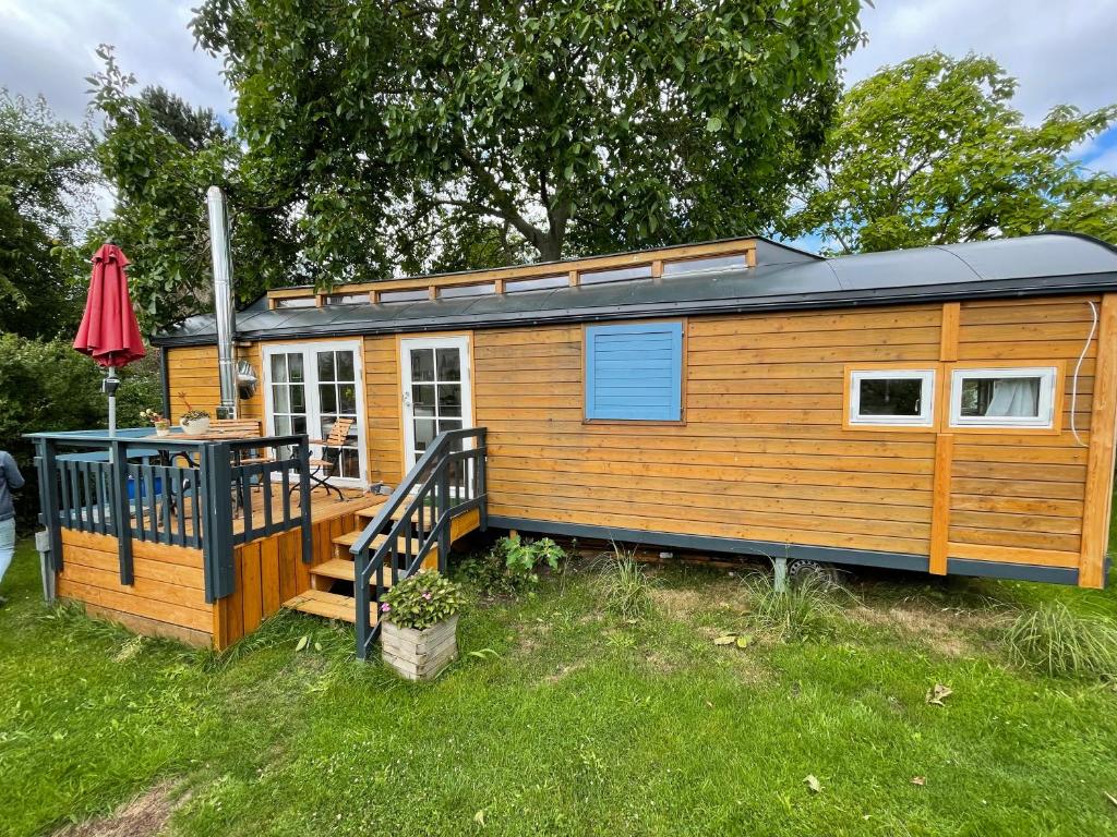 a tiny house with a porch and a deck at Tiny House Ostsee # Naturwerk in Pruchten