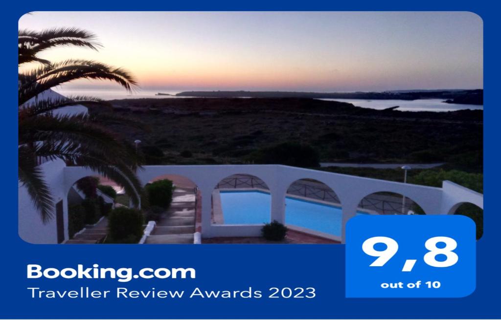 a view of a villa with a palm tree at CASA MAR - NA NURI Menorca in Son Parc