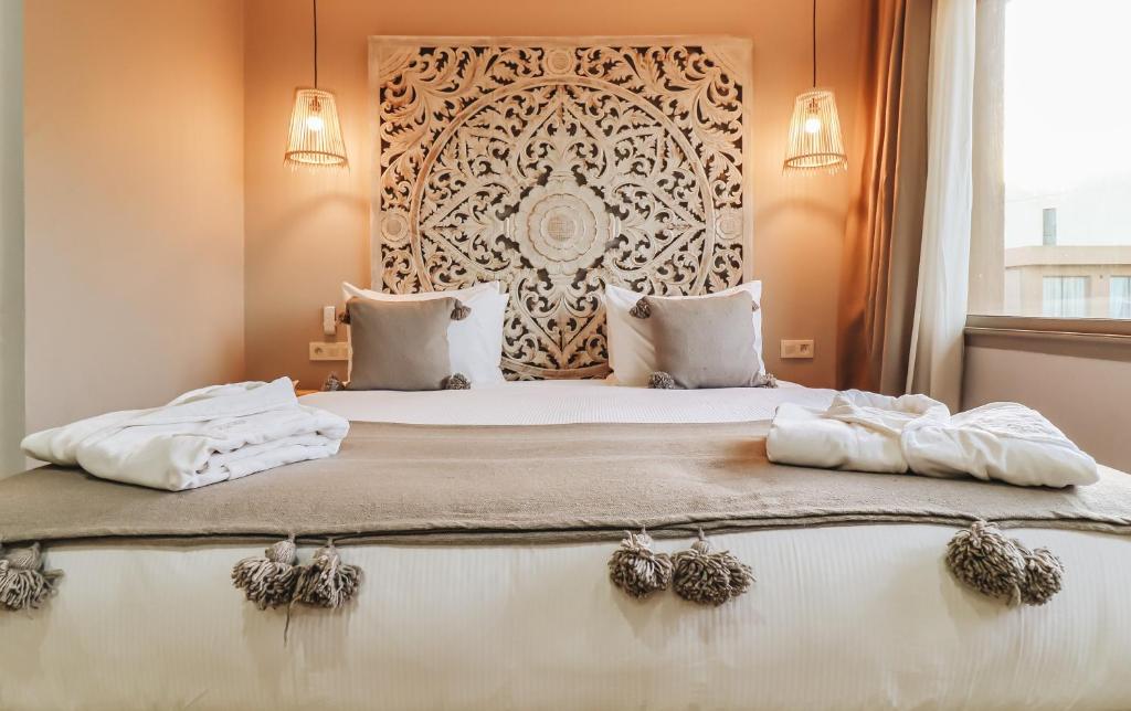 a bedroom with a large bed with two pillows at Tulum Beach Resort Dakhla in Dakhla