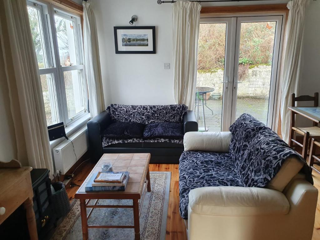 a living room with a couch and a coffee table at Cosy self contained cottage with stunning views in Killaloe