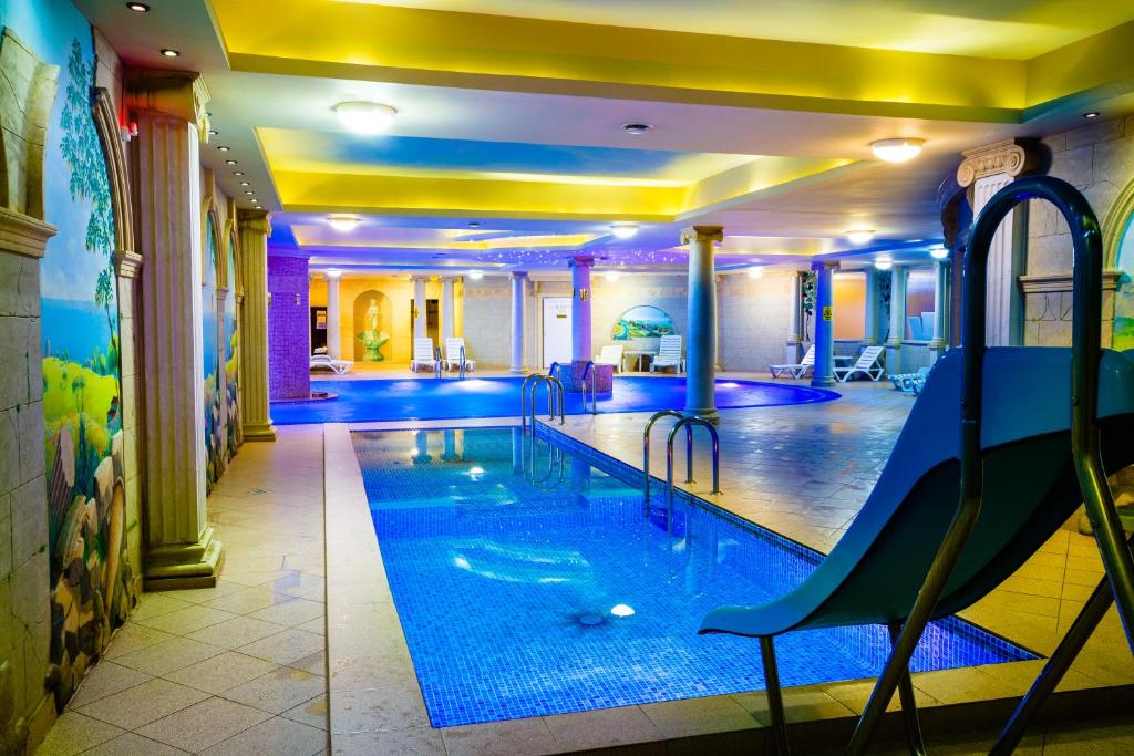 a swimming pool with a blue floor and blue walls at Spa Hotel Gloria in Przemyśl