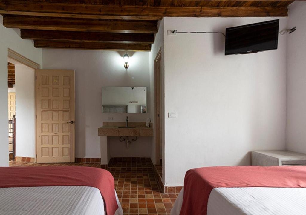Postel nebo postele na pokoji v ubytování Hotel & Temazcal Hacienda Maxthá