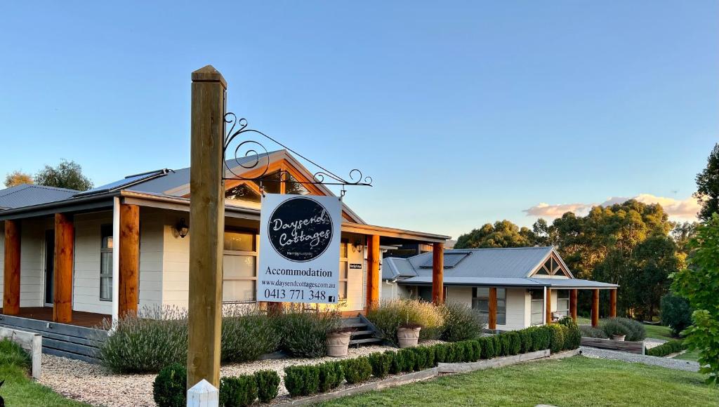 a restaurant with a sign in front of a building at Daysend Cottages in Merrijig