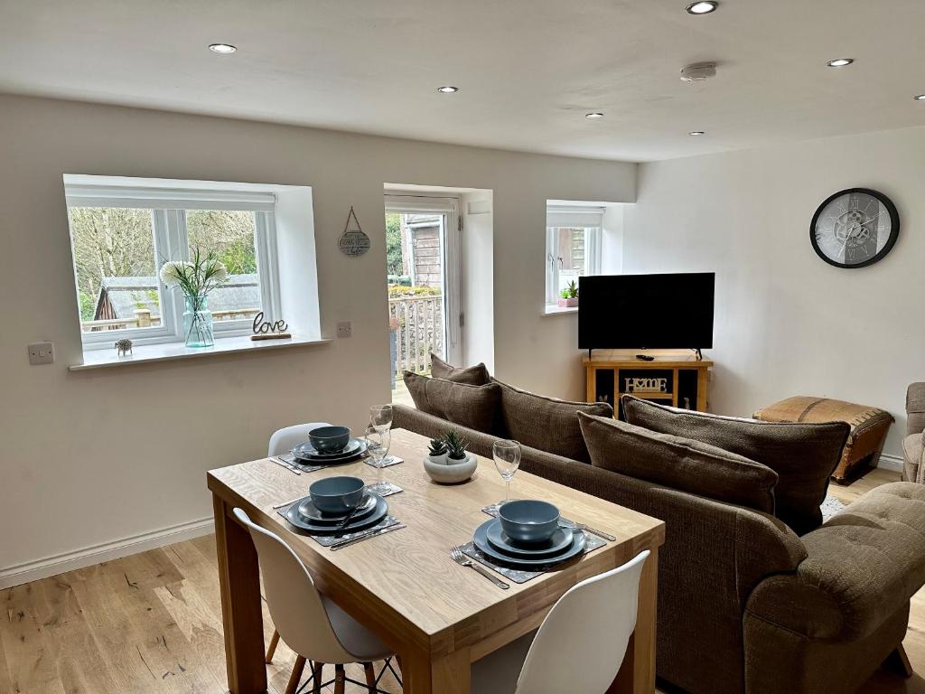 a living room with a table and a couch at Brechin Townhouse - Cathedral View in Brechin