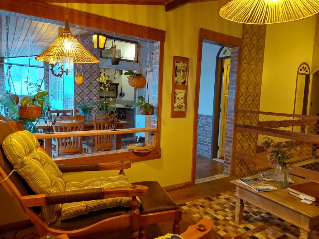 a living room with a couch and a dining room at Casa de Praia Alameda Azul in Guarapari