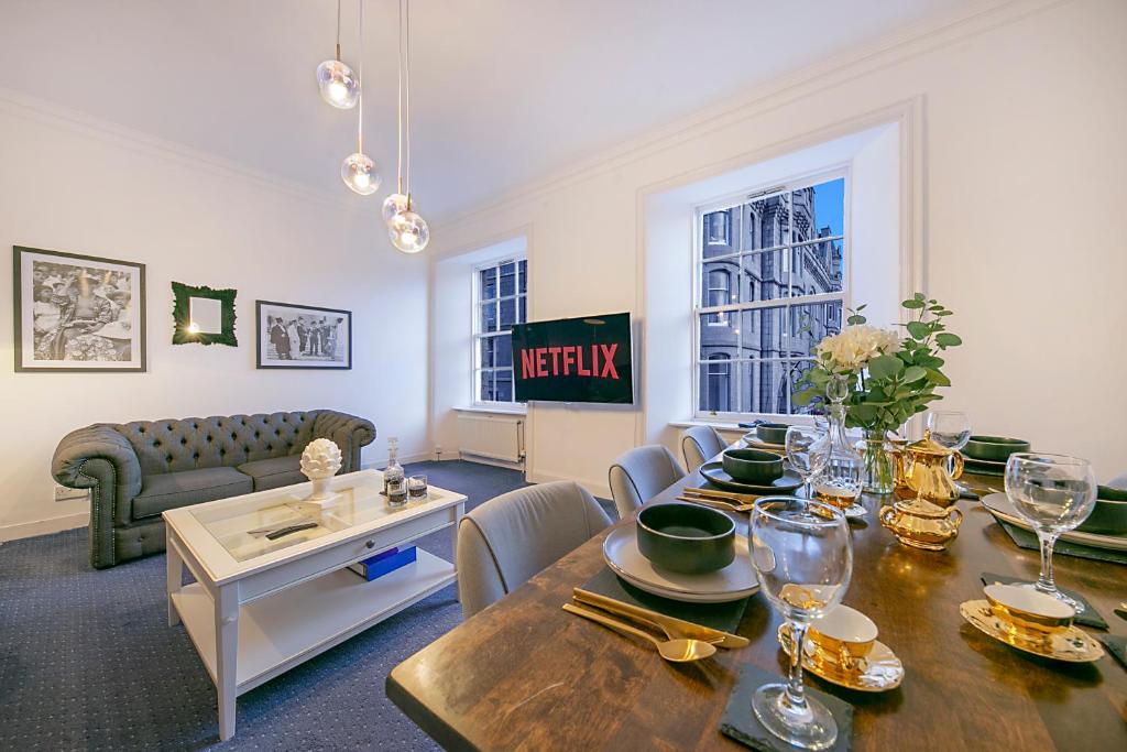 a living room with a table and a couch at Castle Street Apartments ✪ Grampian Lettings Ltd in Aberdeen