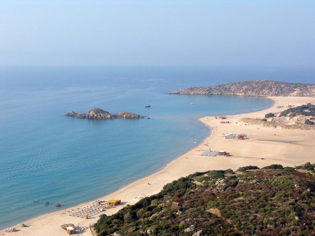 an aerial view of a beach with people on it at Hotel Spartivento in Chia
