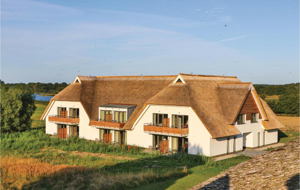 a large white house with a brown roof at Fewo 34 Putbus-rgen in Wreechen