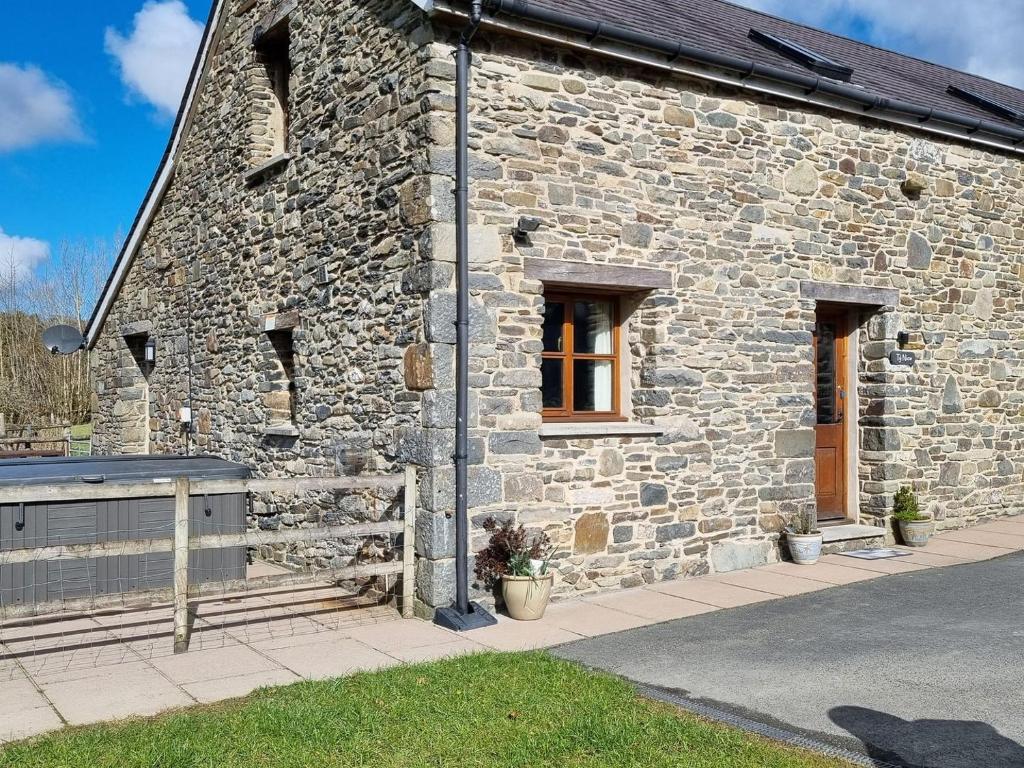 a stone building with two windows on the side of it at Ty Nicw - W42765 in Blaenpenal