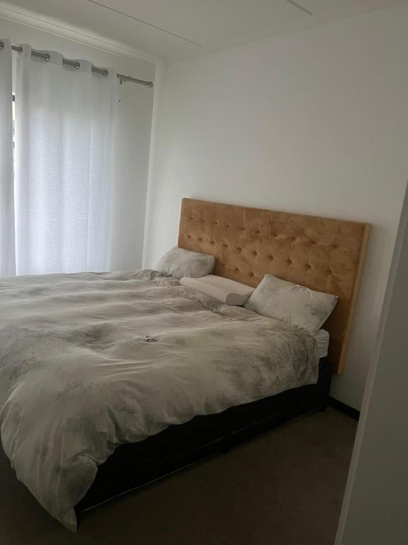 a bedroom with a large bed with a wooden headboard at The view complex in Sandton