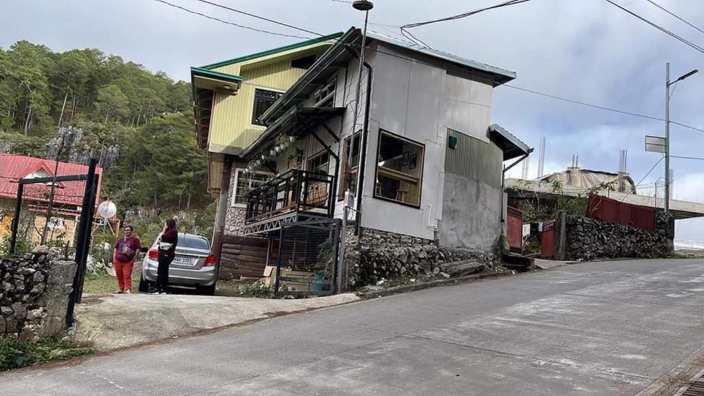 a house that is sitting on the side of a street at Domay's Homestay ( Main) 