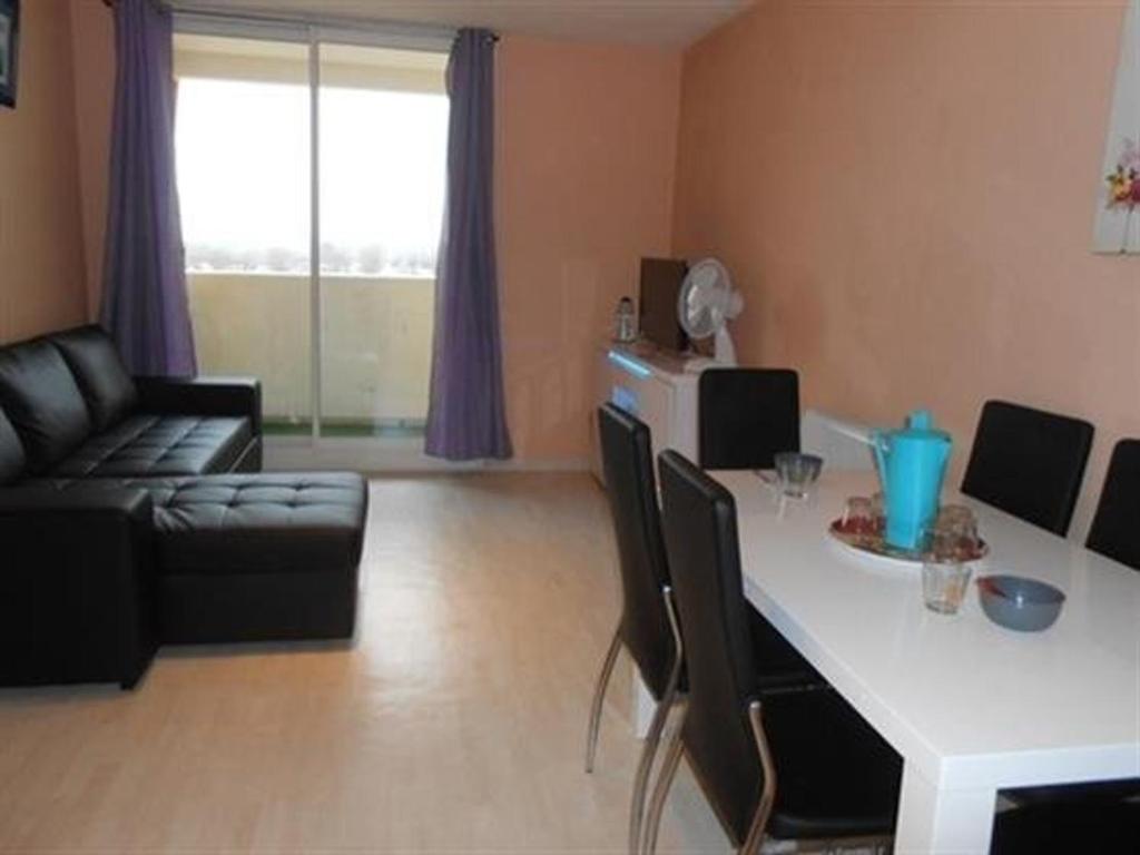 uma sala de estar com uma mesa e um sofá em Appartement Saint-Hilaire-de-Riez, 3 pièces, 6 personnes - FR-1-324A-21 em Saint-Hilaire-de-Riez