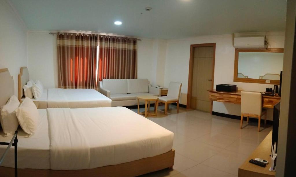 Postel nebo postele na pokoji v ubytování PUNTA CLARK HOTEL