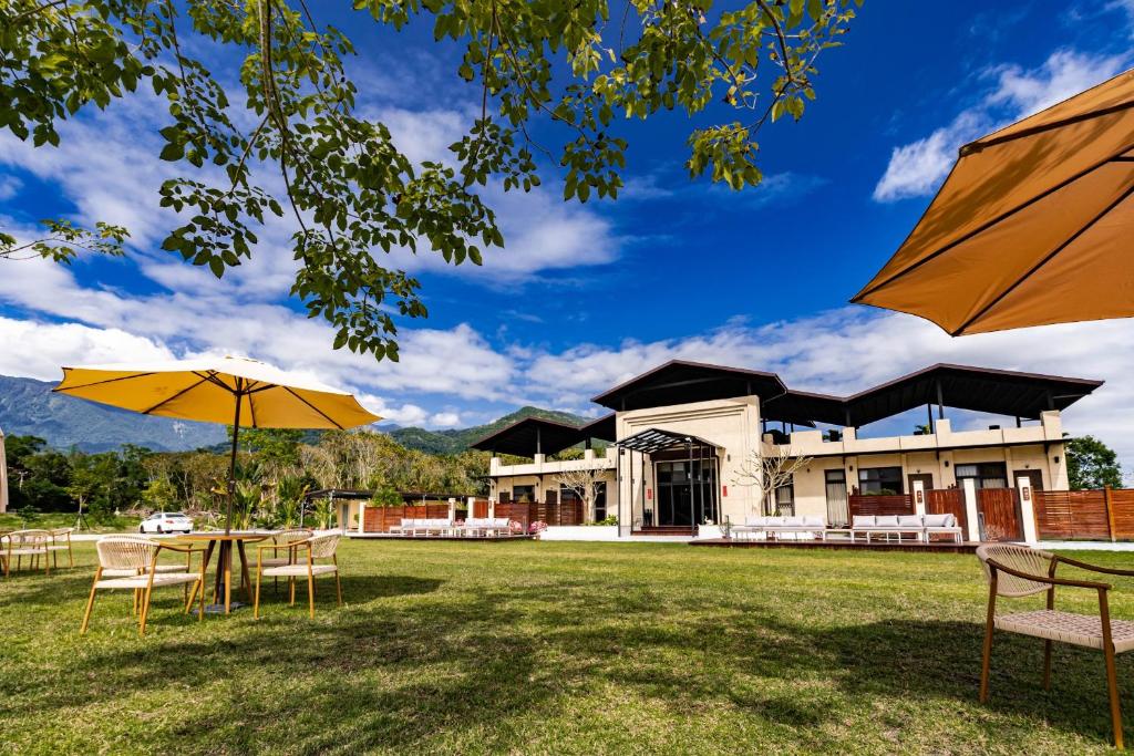 a view of a building with tables and umbrellas at W Starry Villa in Ruisui