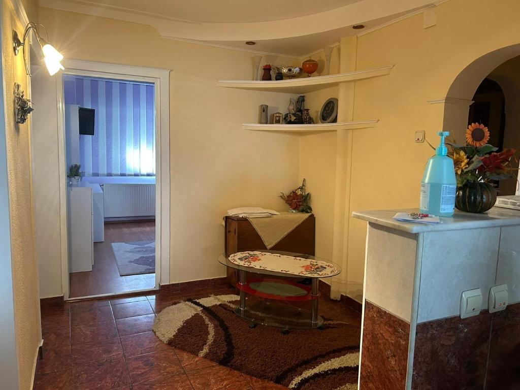 a living room with a table and a room at Apartament Onesti in Onești