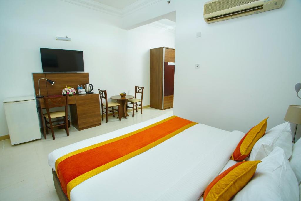 Postel nebo postele na pokoji v ubytování La Villa Palace Hotel